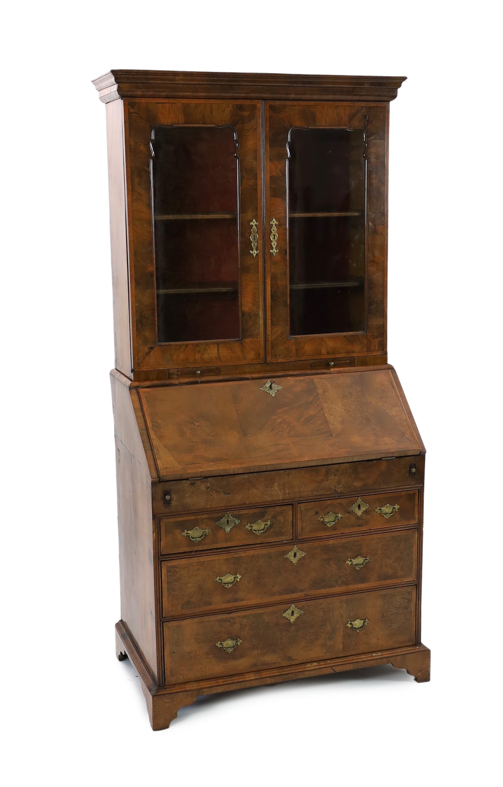 An early 18th century feather banded walnut bureau bookcase, width 96cm depth 57cm height 198cm